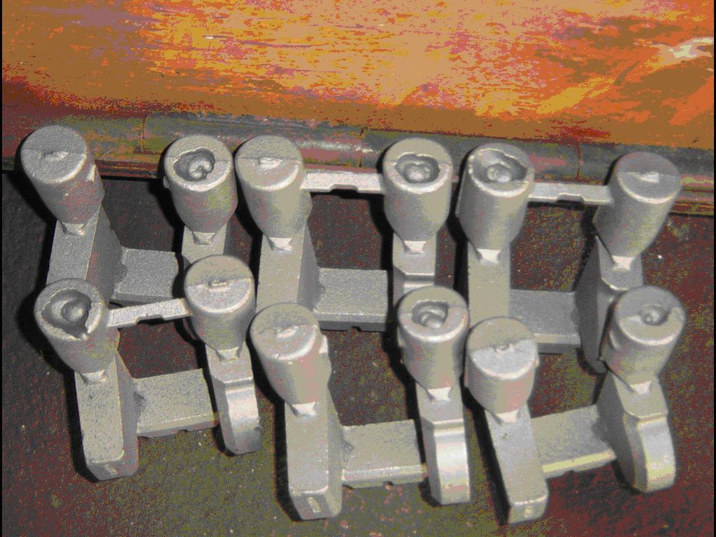 metal casting with a cylindrical riser still attached before cutting