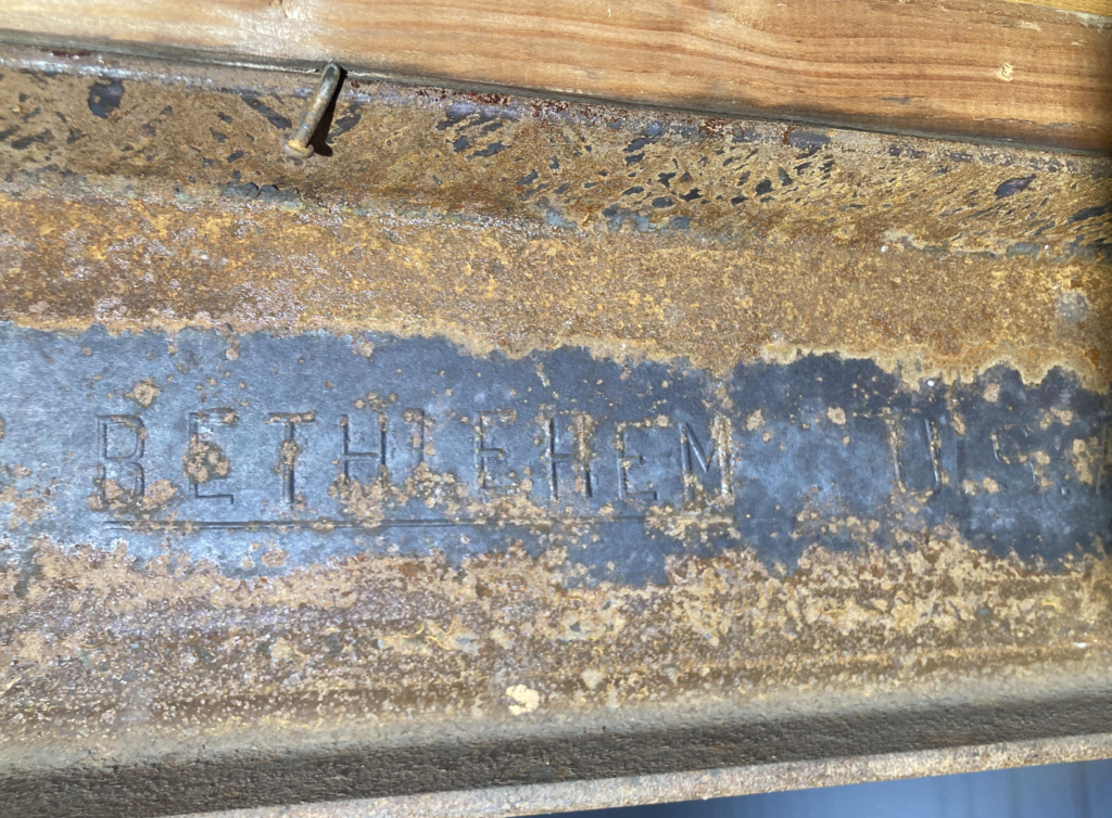 rusted steel surface next to a painted section, showing why corrosion prevention matters