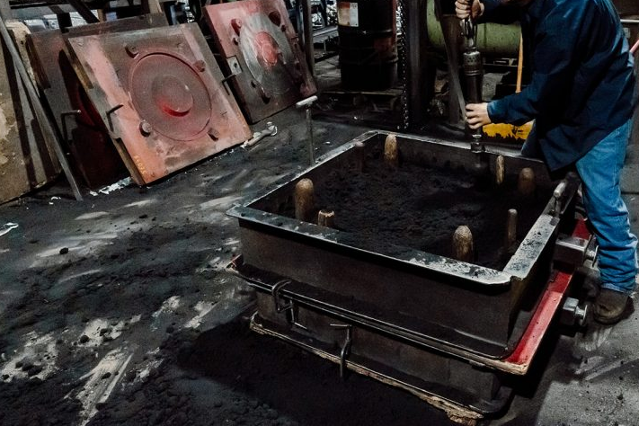 making sand mold in a flask on a foundry floor